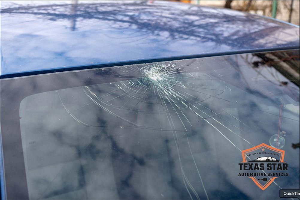 A close up of a broken windshield on a car.