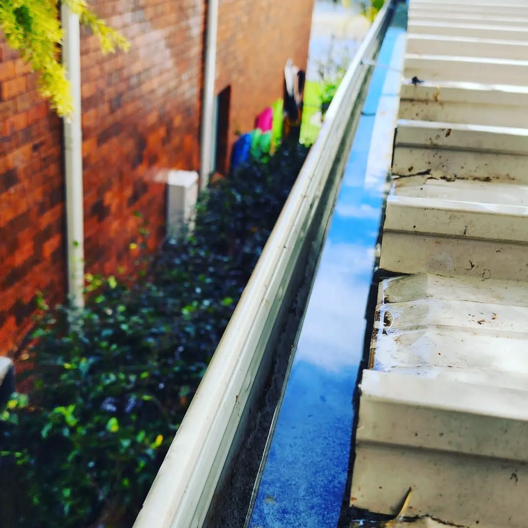 A Brick Building With Stairs Leading Up to It — TK Guttercleaning in Hamlyn Terrace, NSW