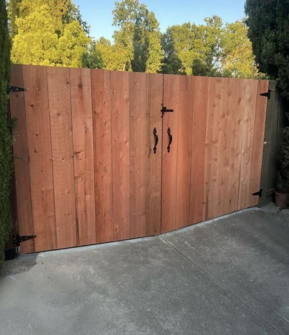a close up of a wooden fence with trees in the background .