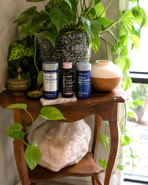Therapist assisting a client on a massage table in a calm treatment room