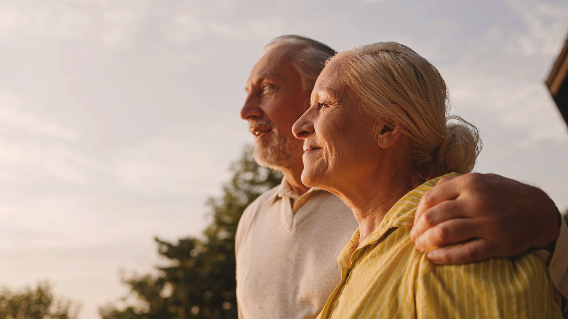 Retired couple enjoying sunset together, representing secure retirement planning and financial peace of mind in Kansas City