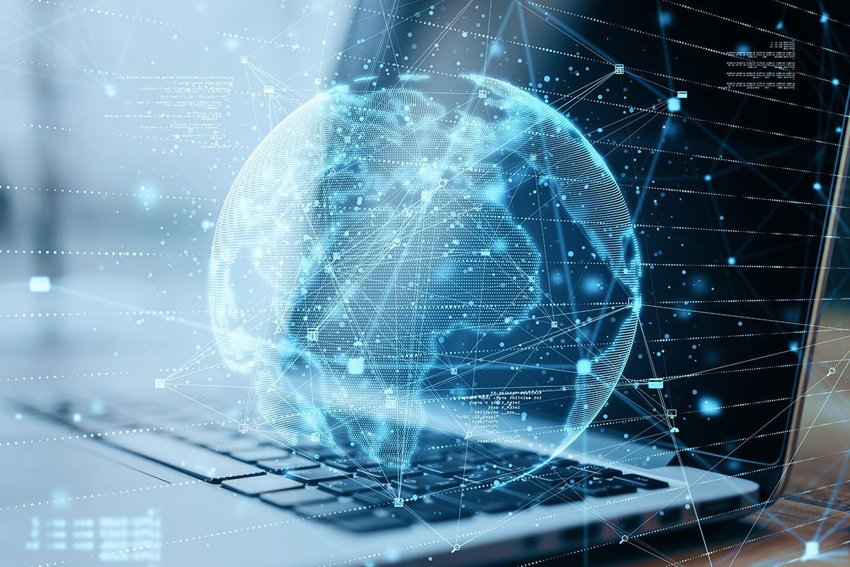 Laptop with glowing digital globe and data network overlay, suggesting cloud computing or cybersecurity