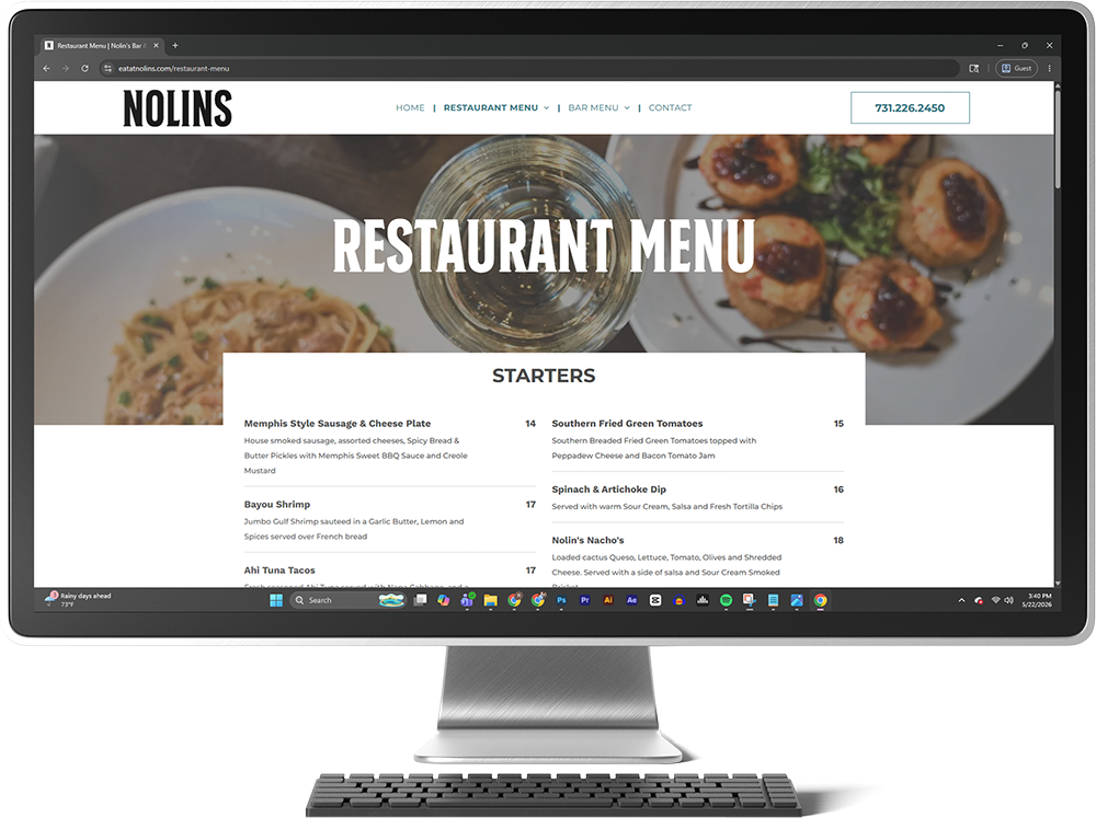 Restaurant menu webpage on a desktop monitor with large food photos and starter listings