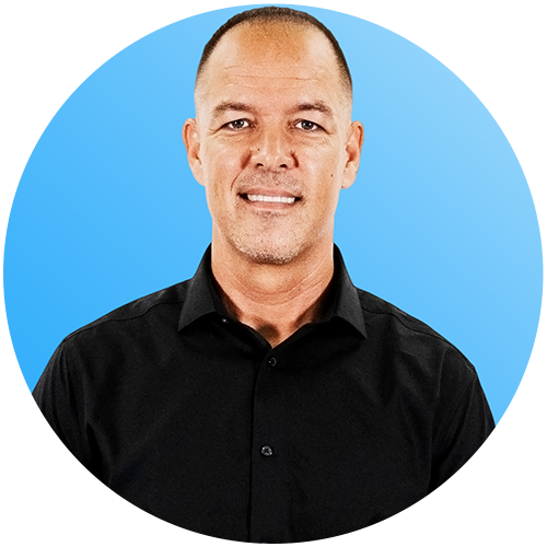 Professional headshot of a man in a gray suit and black tie on a blue background