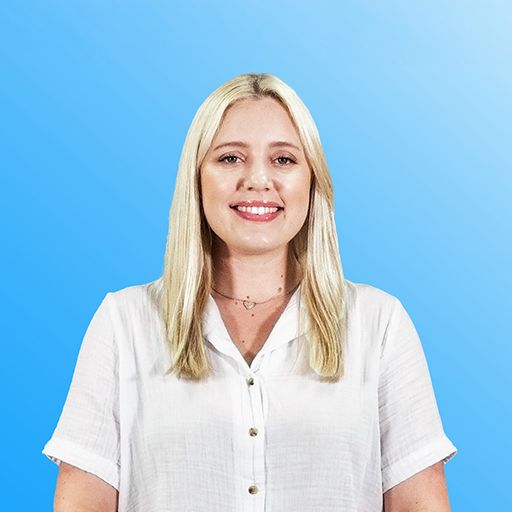 Smiling woman in a black-and-white checkered blazer against a blue background