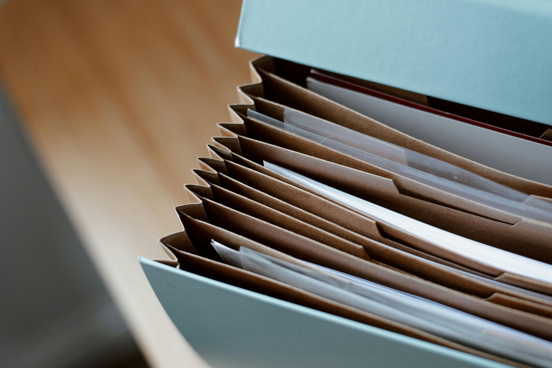 Open folder with stacked documents and brown tabs