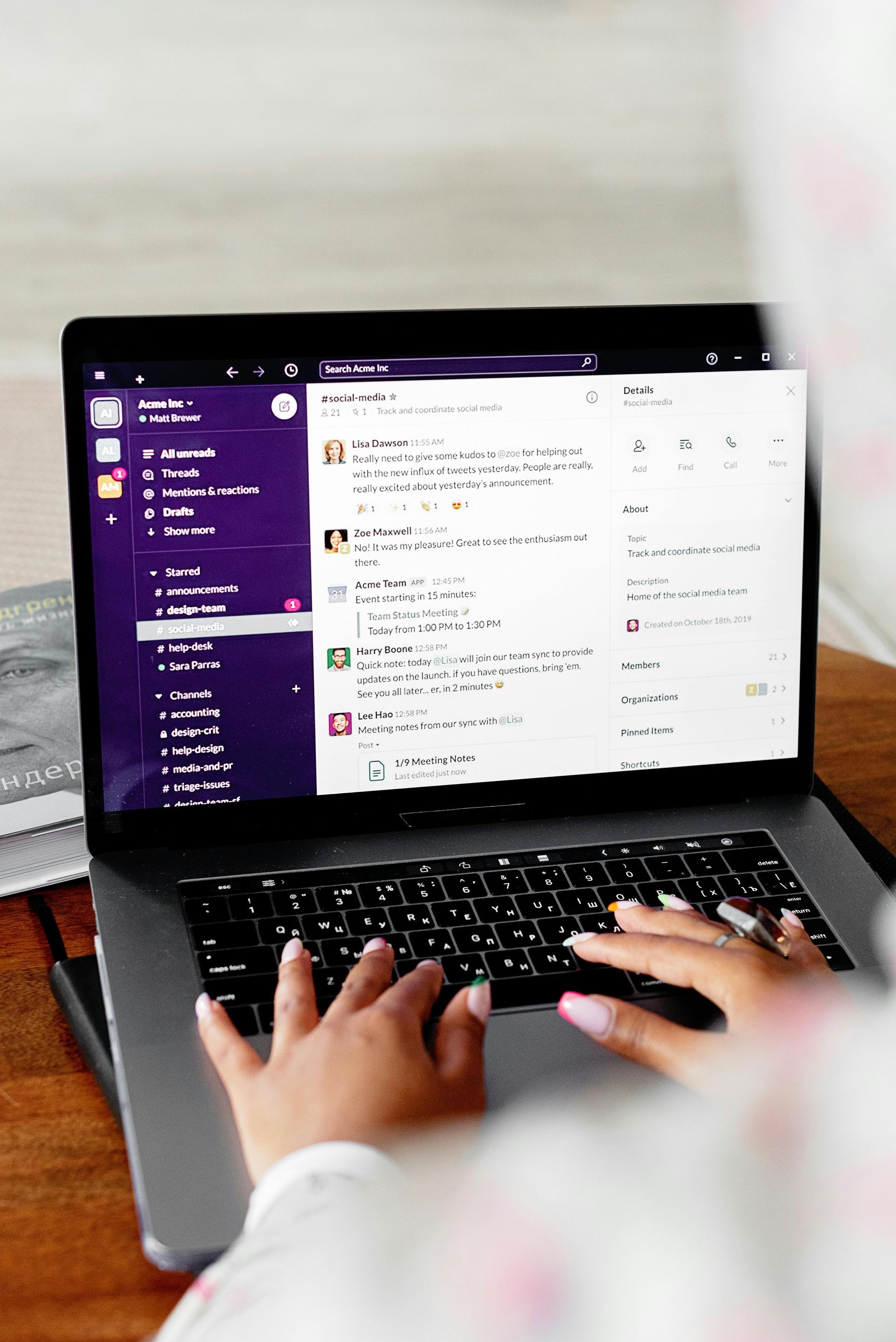 Hands typing on a laptop with a purple email inbox open on screen.