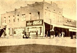 Sepia-toned street scene with a corner Coca-Cola shop and pedestrians outside old storefronts.