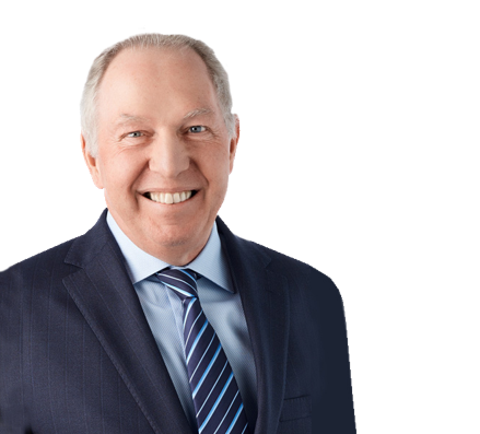A man in a suit and tie is smiling for the camera