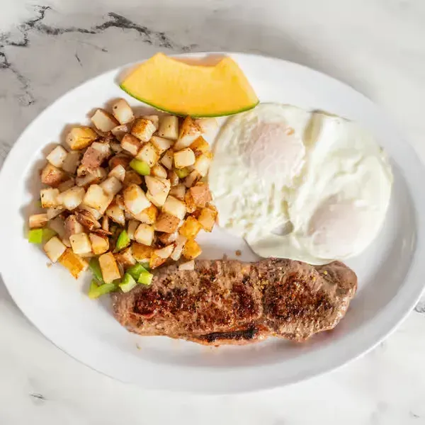 Breakfast plate with fried egg, potatoes, sausage and melon at Hollywood Family Café Lodi