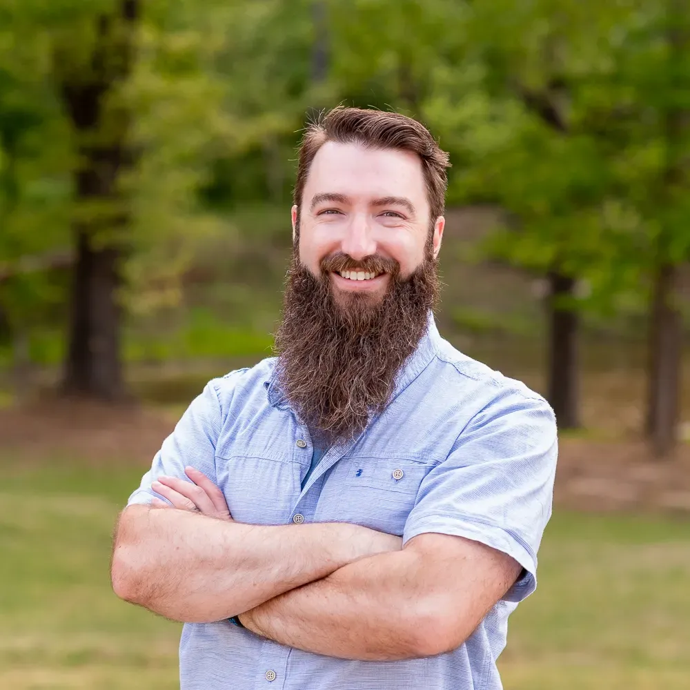Smiling bearded man in a light blue shirt