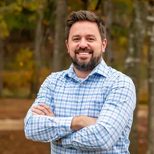 A smiling person with a beard