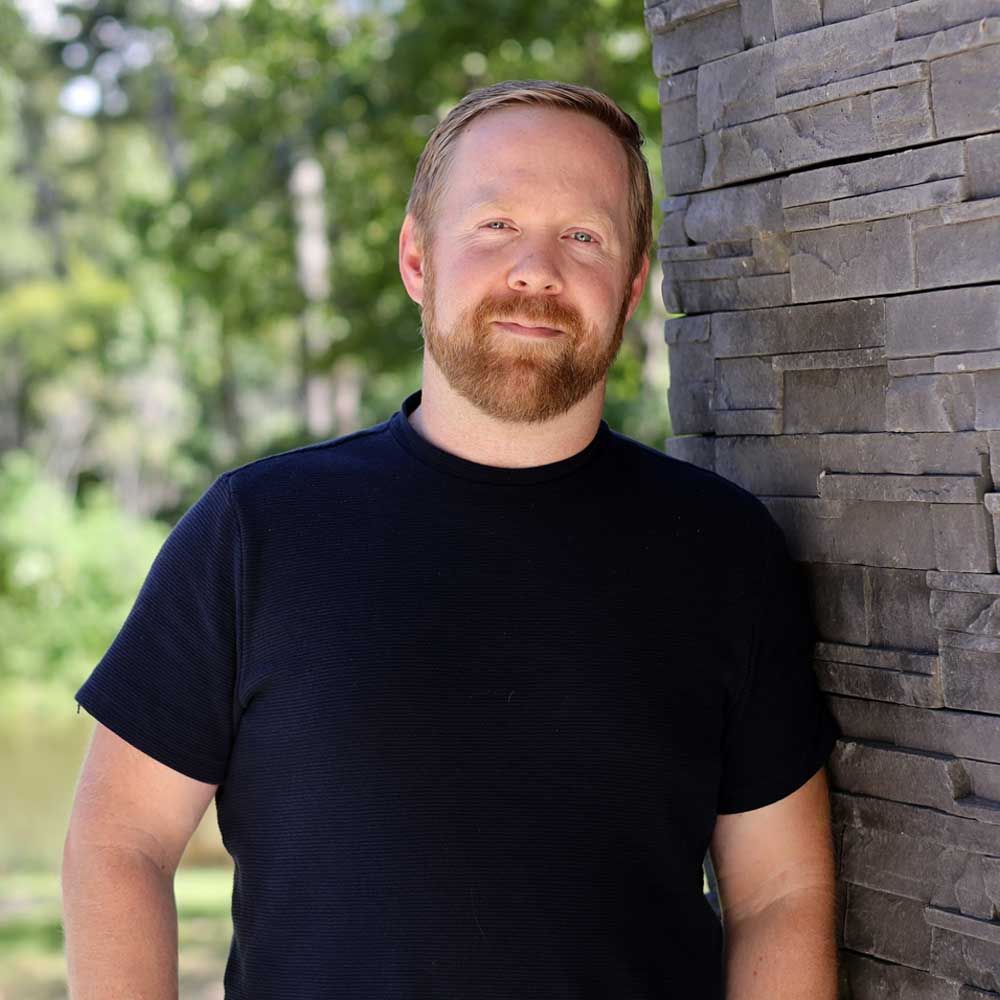 A person with a beard and dark shirt
