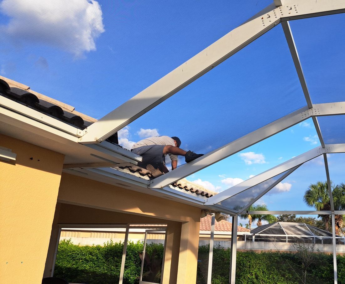 A man is working on the roof of a house.