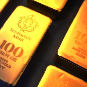 Close-up of gold Scottsdale Mint silver bars with engraved weight and purity markings.