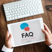 Blue FAQ key with a red question mark on a computer keyboard