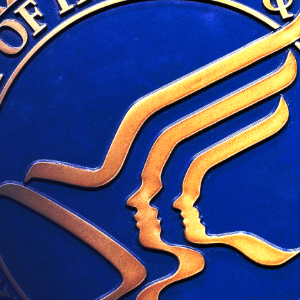 Blue and gold circular logo with a stylized bird and three profile faces