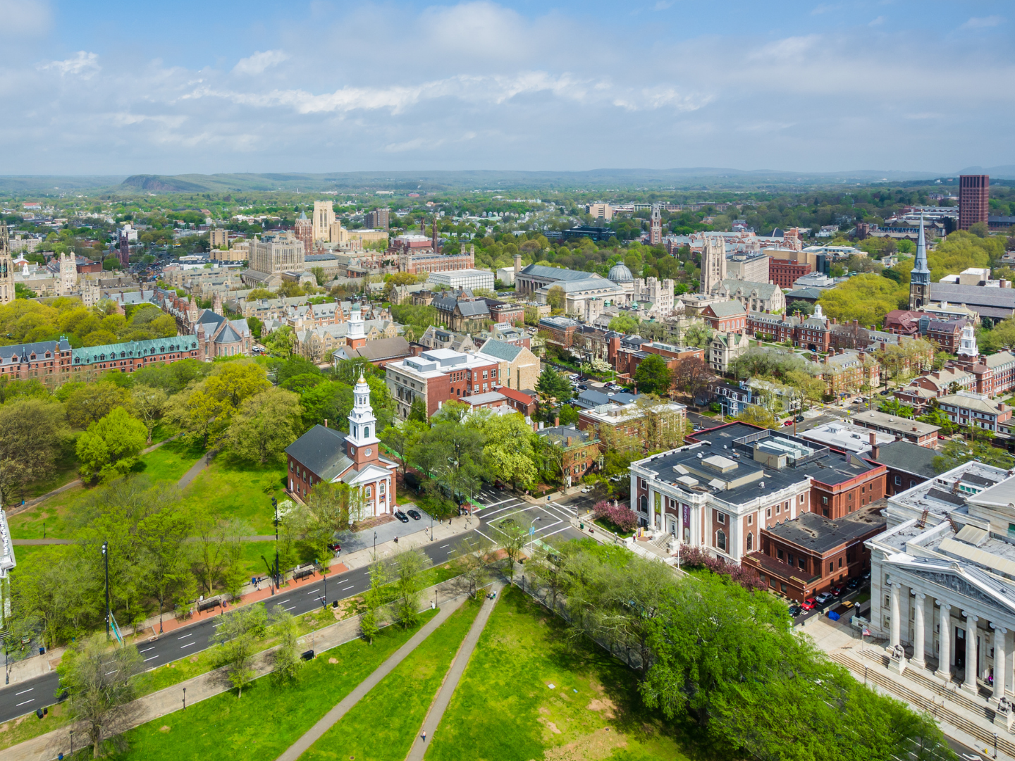 An aerial view of a city with lots of buildings and trees.