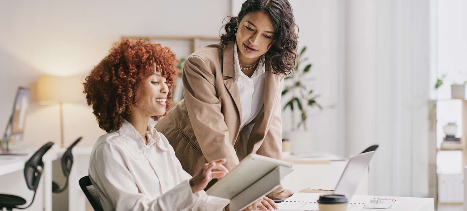 A man and a woman are sitting at a table having a conversation.