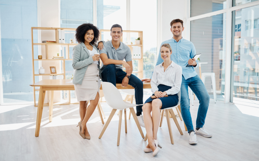 A group of people are sitting around a table having a meeting.