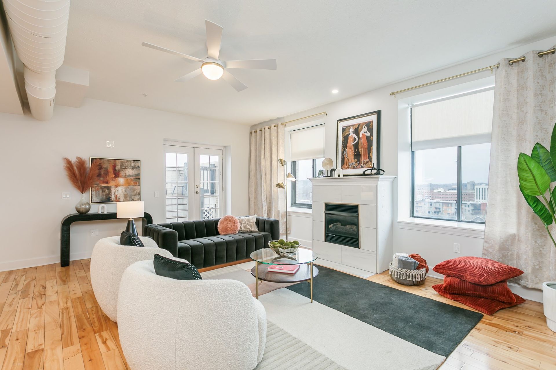 Living room with hardwood floors and private balcony