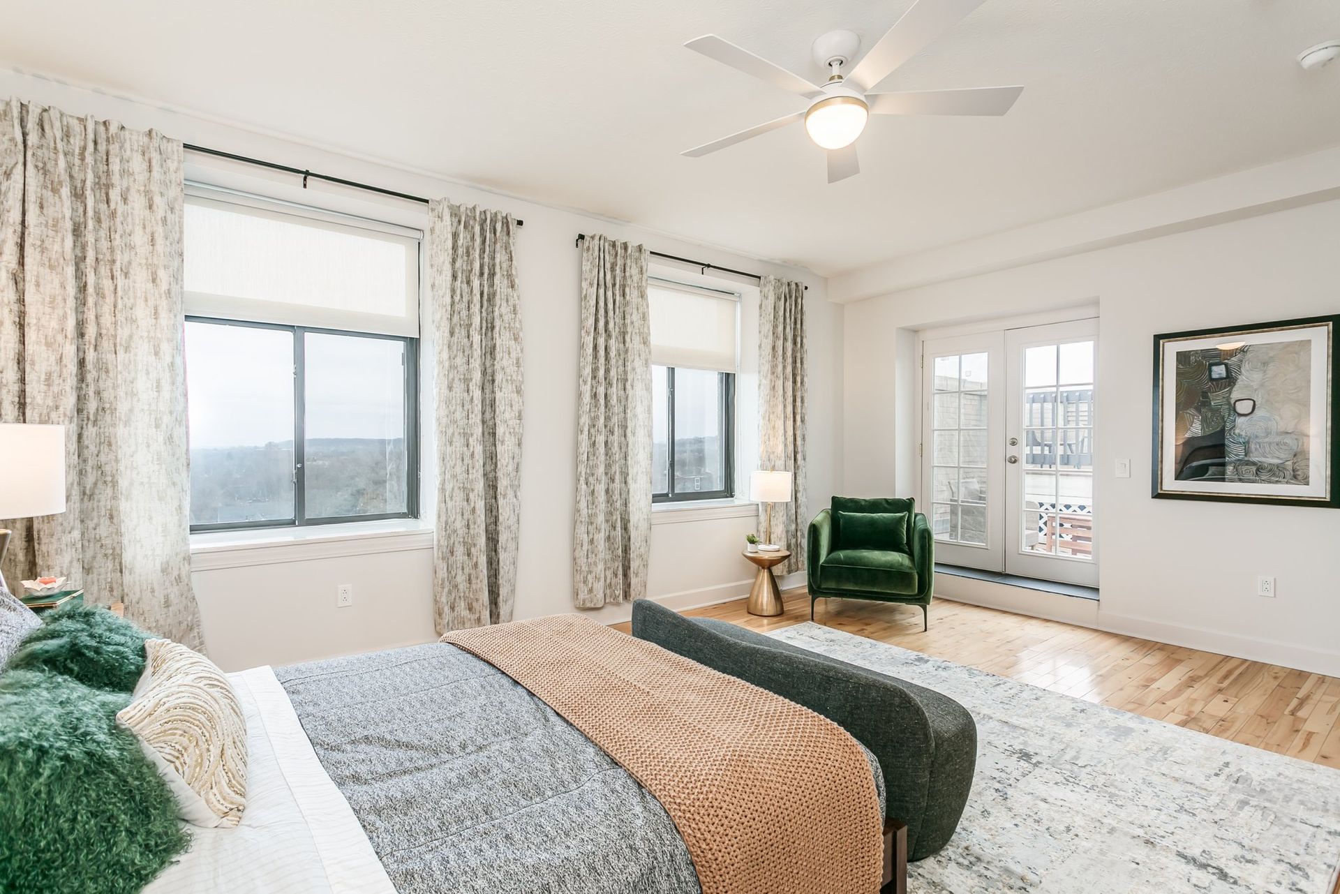 Large bedroom with bright natural lighting and private balcony