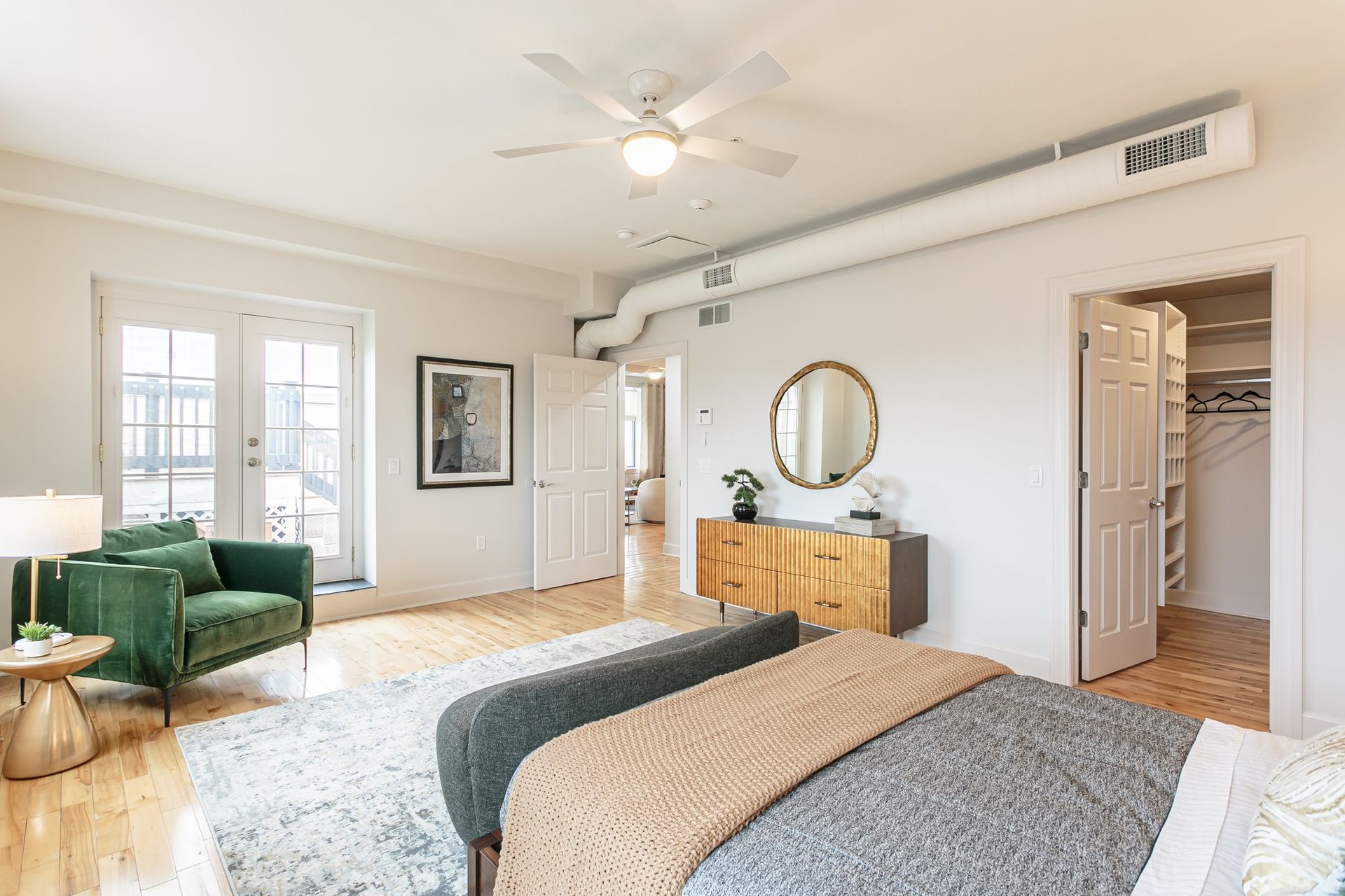 Large bedroom with hardwood floors, walk-in closet, and ensuite bathroom.