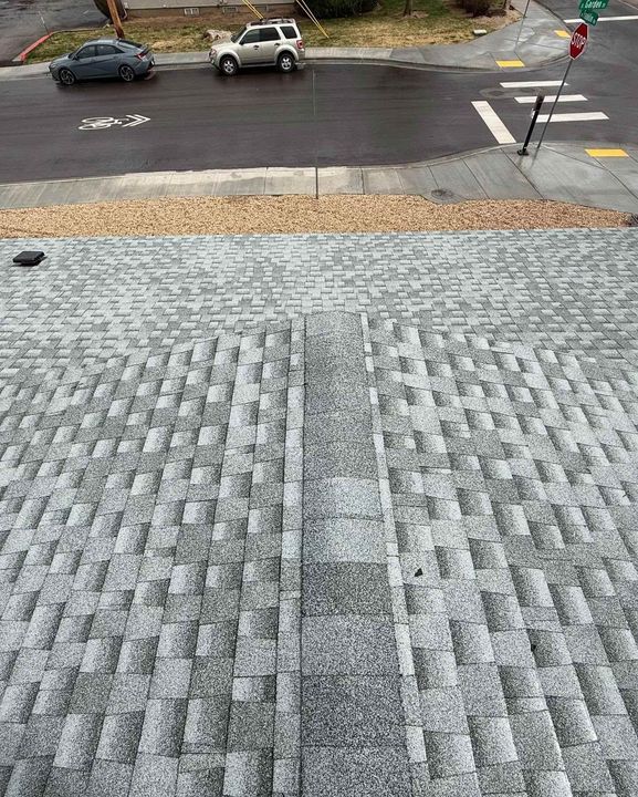 Steep textured stone walkway leading to a street with parked cars and a sidewalk crossing.