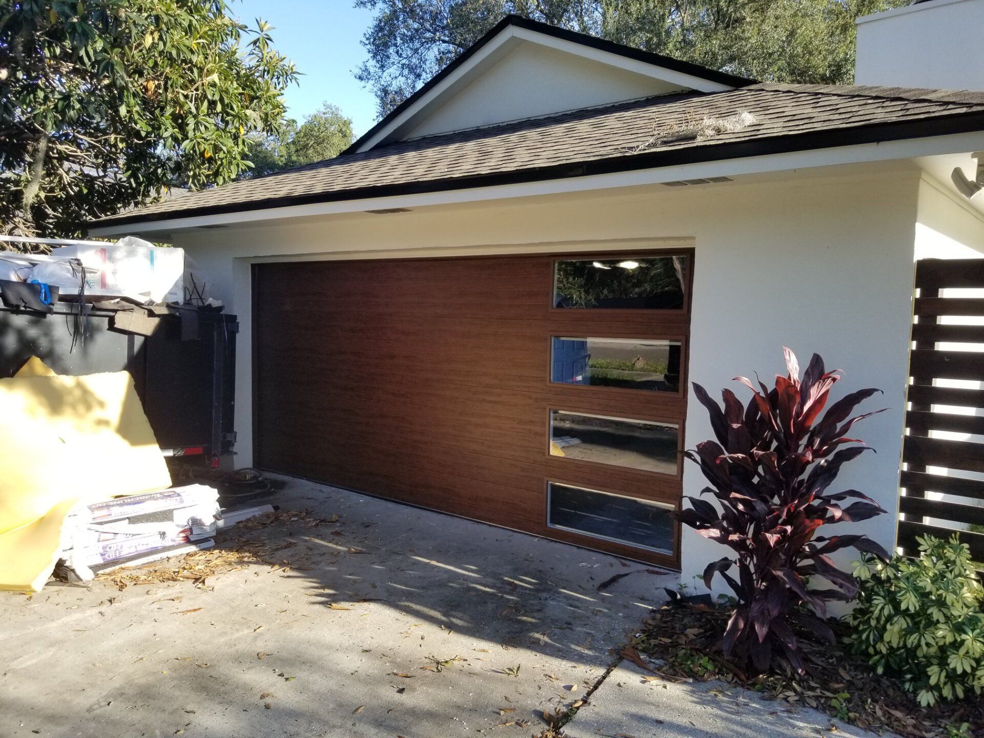 A white house with a wooden garage door