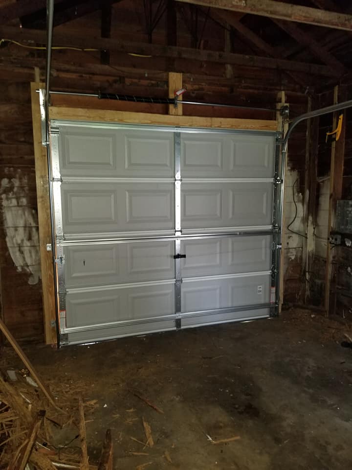 A garage door is being installed in a garage.