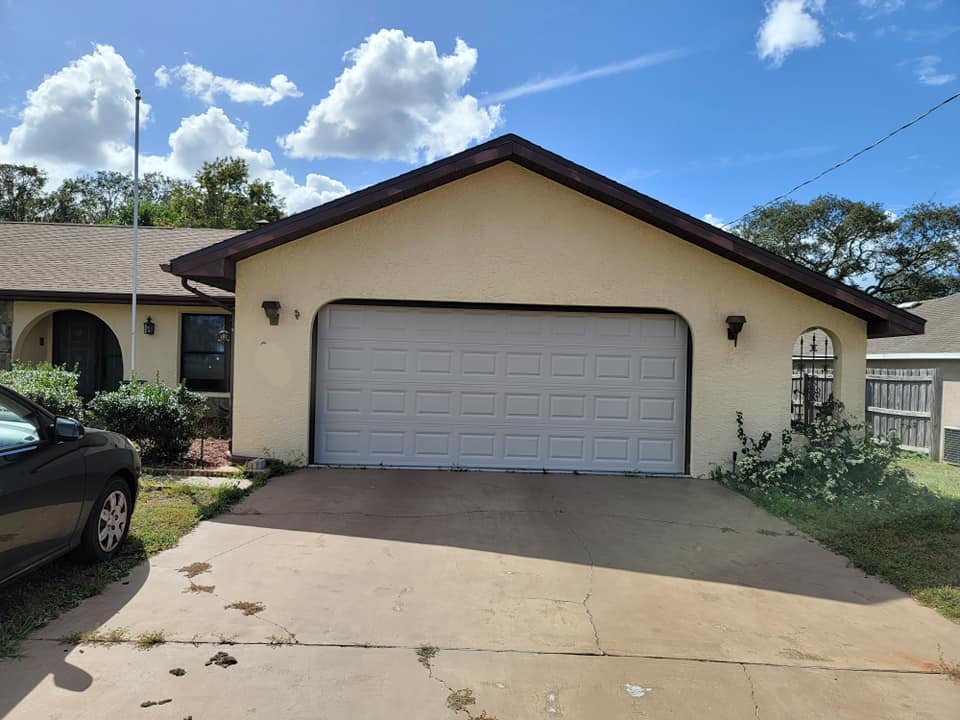 The front of a house with a garage door.