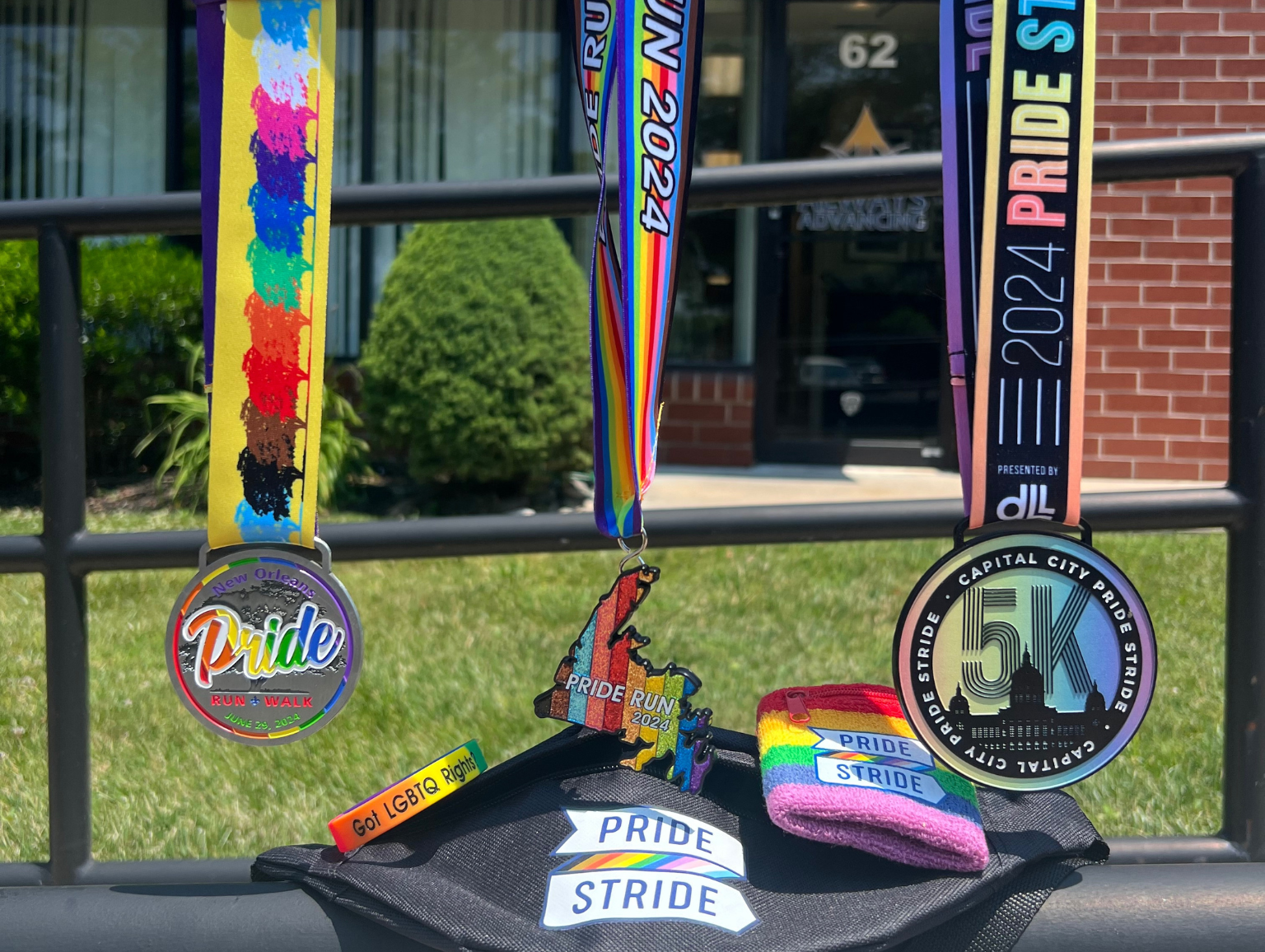 A collection of Prinde Month medals are sitting on top of a graduation cap.