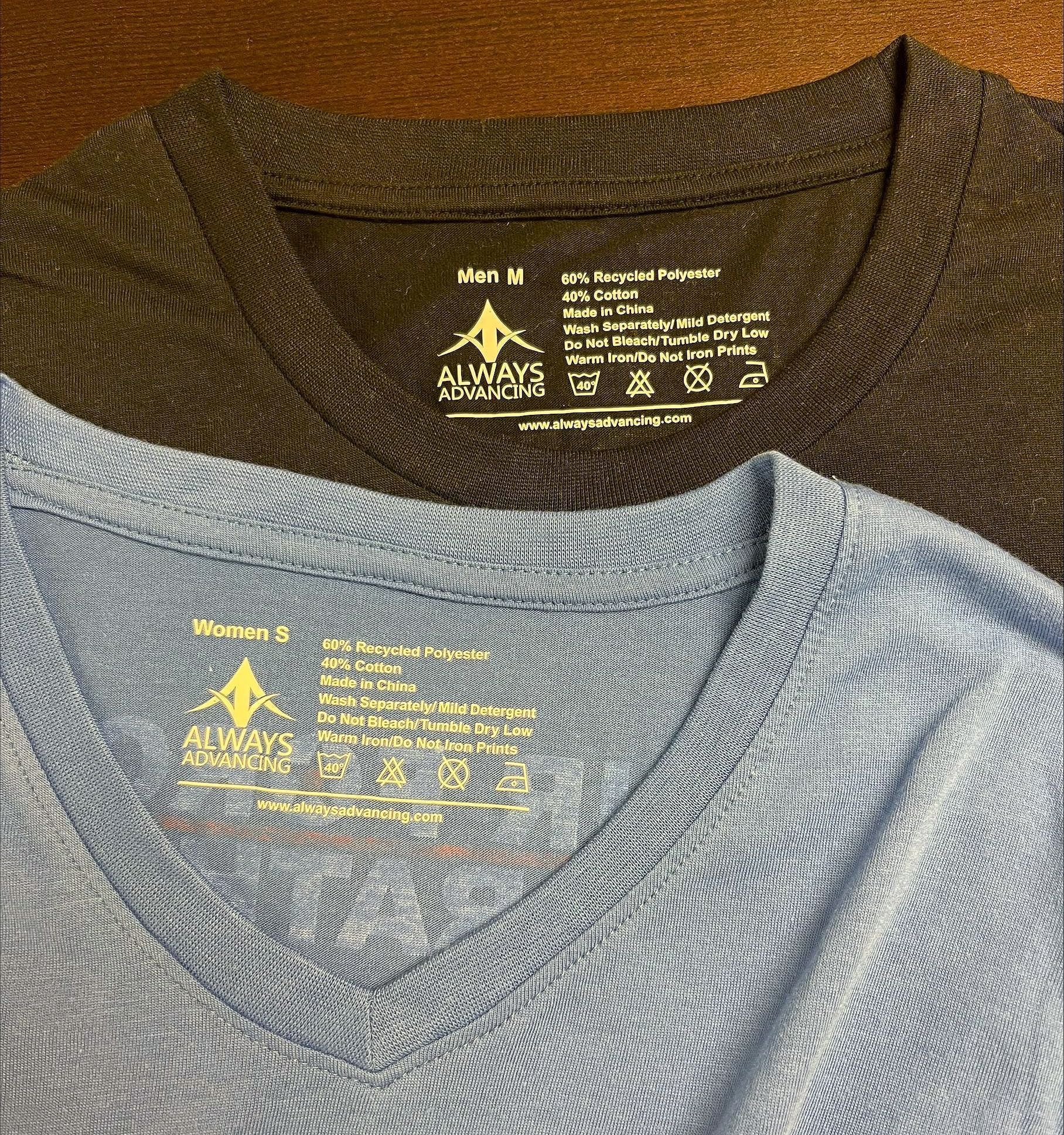 Two t-shirts are sitting next to each other on a table showing sustainability care tags.
