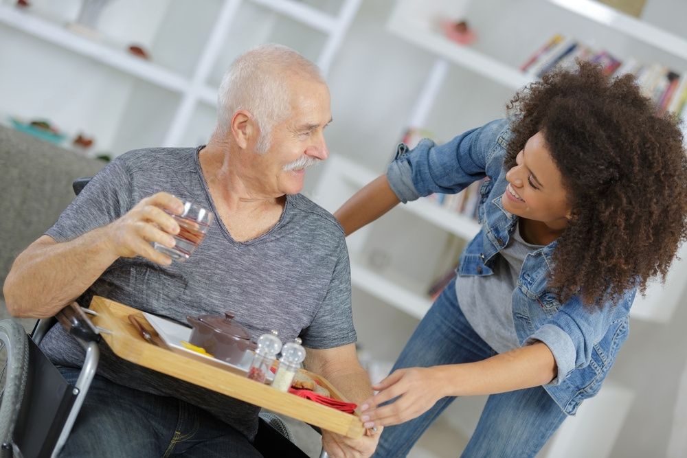A woman and elderly man smiling