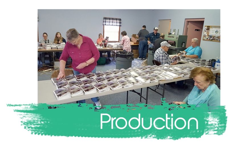 Volunteers sorting magazines on tables in a bright room, with “Production” text overlay.
