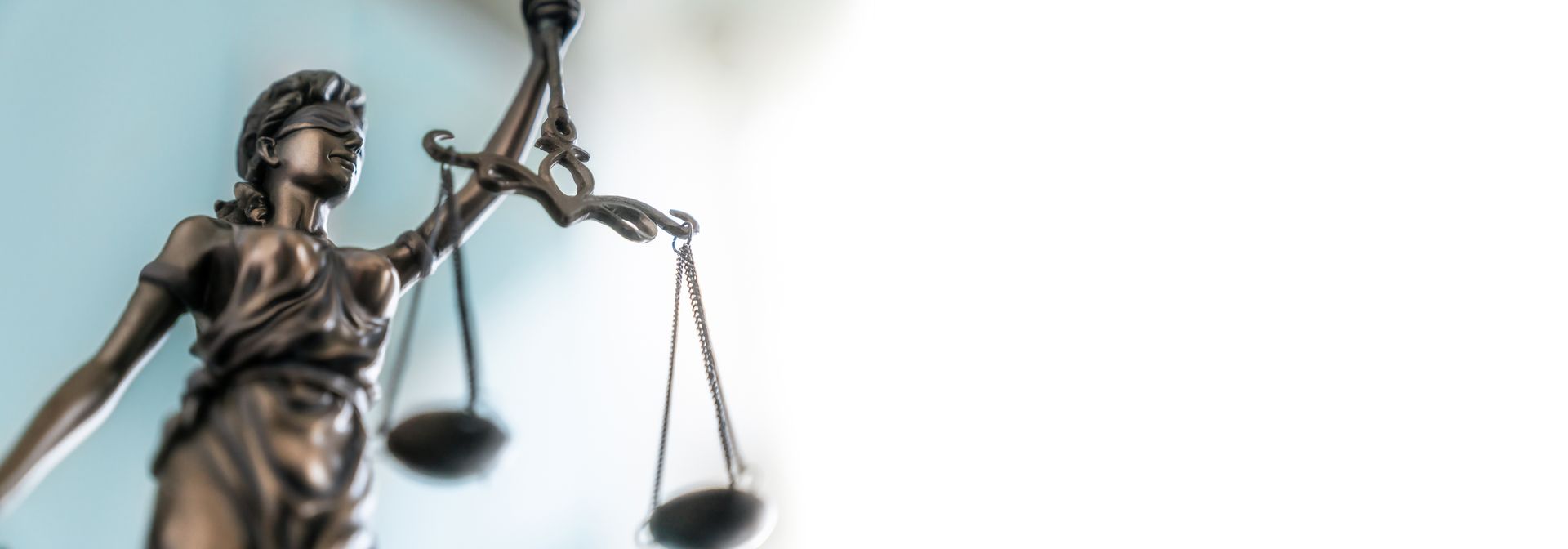 Statue of lady justice on bright background - Side view with copy space. Statue of lady justice on bright background - Side view with copy space.