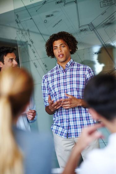 Young man standing and presenting - next gen development