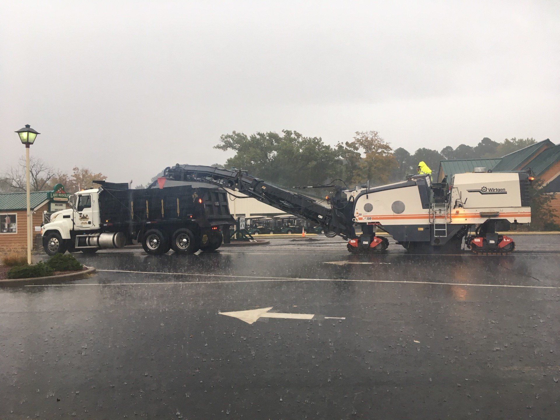 Workers On Truck While Raining — Houston, TX — HEV Asphalt Paving Co.
