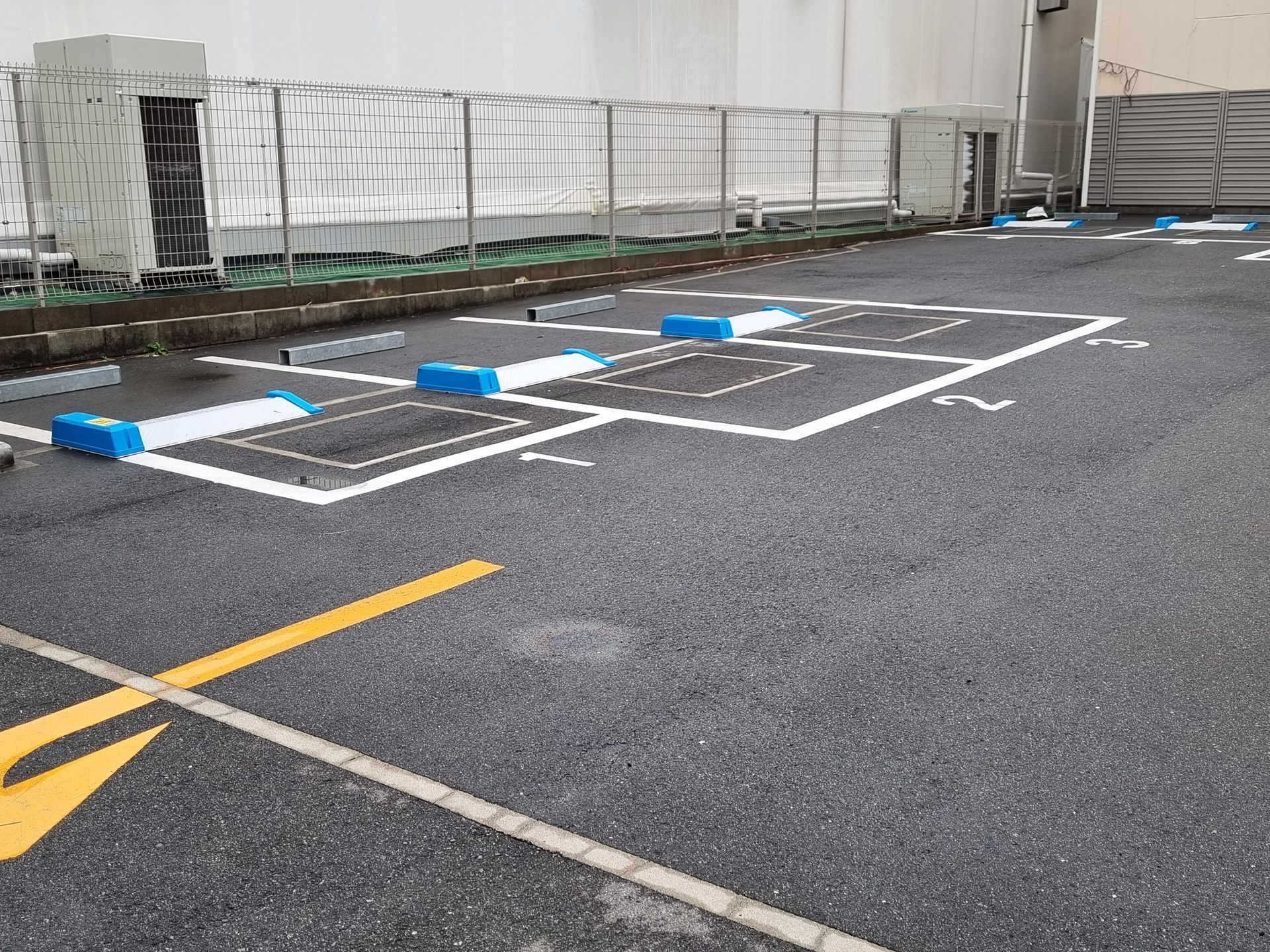parking asphalt services with marked parking spaces, smooth asphalt surface and safety barriers. parking asphalt services with marked parking spaces, smooth asphalt surface and safety barriers.