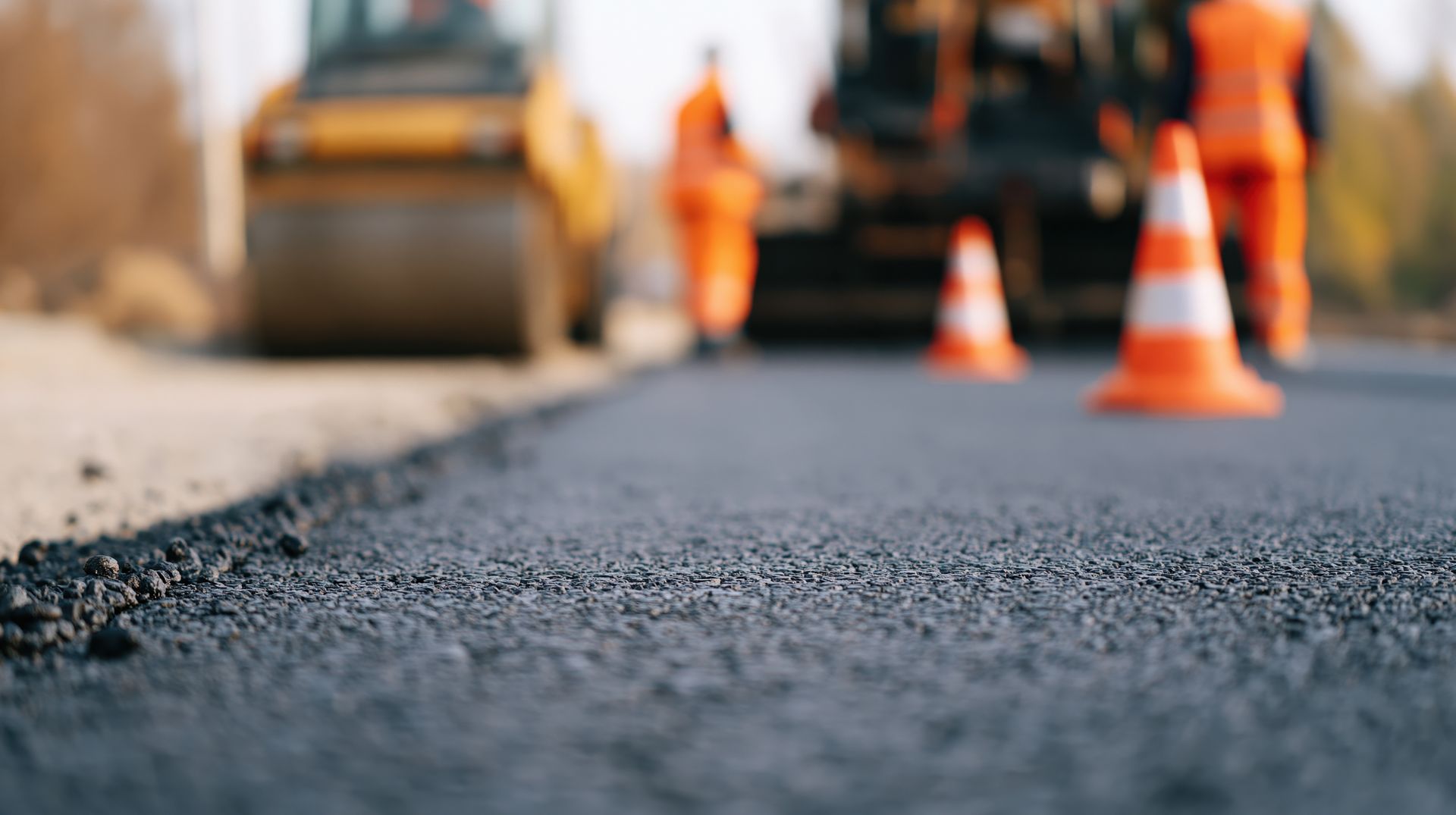 Smooth freshly laid asphalt road showcasing expert commercial paving repair services in progress.