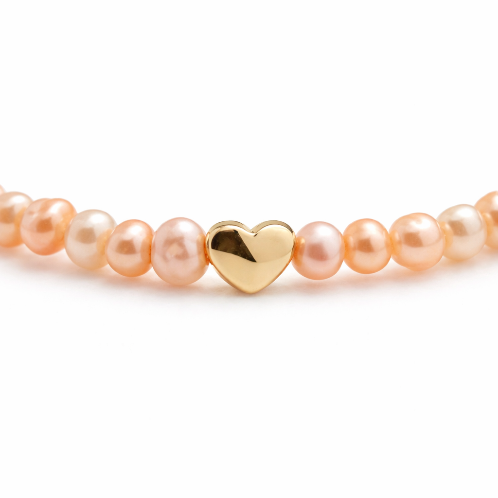 Handgemaakte armband met roze zoetwaterparels van 4mm en goudkleurig stainless steel hartje