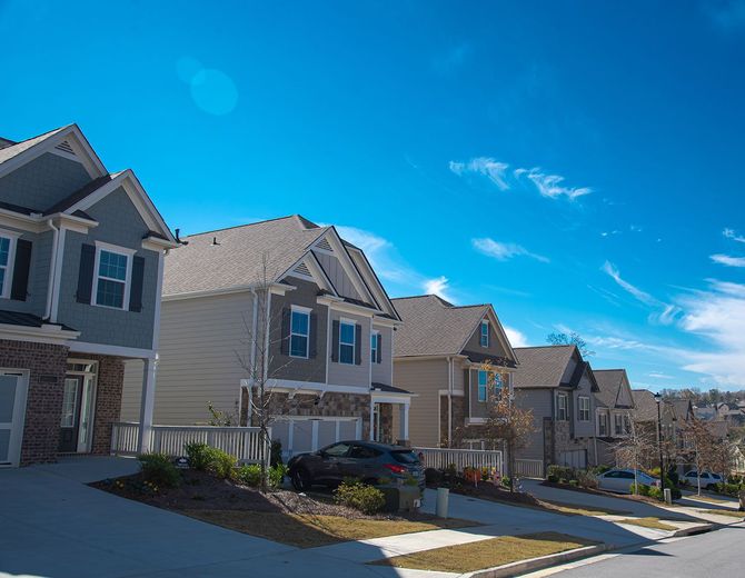 A row of modern suburban houses on a street A row of modern suburban houses on a street
