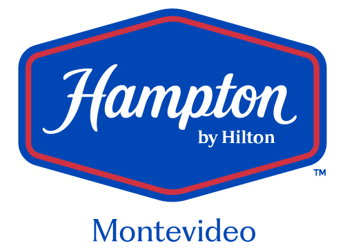 Logotipo de Hampton by Hilton con el texto Montevideo Carrasco sobre fondo blanco.