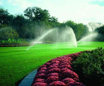 Sprinkler irrigation system watering lawn and landscaping