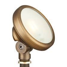 Brass-colored outdoor spotlight with round frosted glass lens on adjustable mount