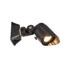 Black adjustable wall-mounted spotlight with a lit bulb on a white background