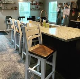 A kitchen with a table and chairs and a sink