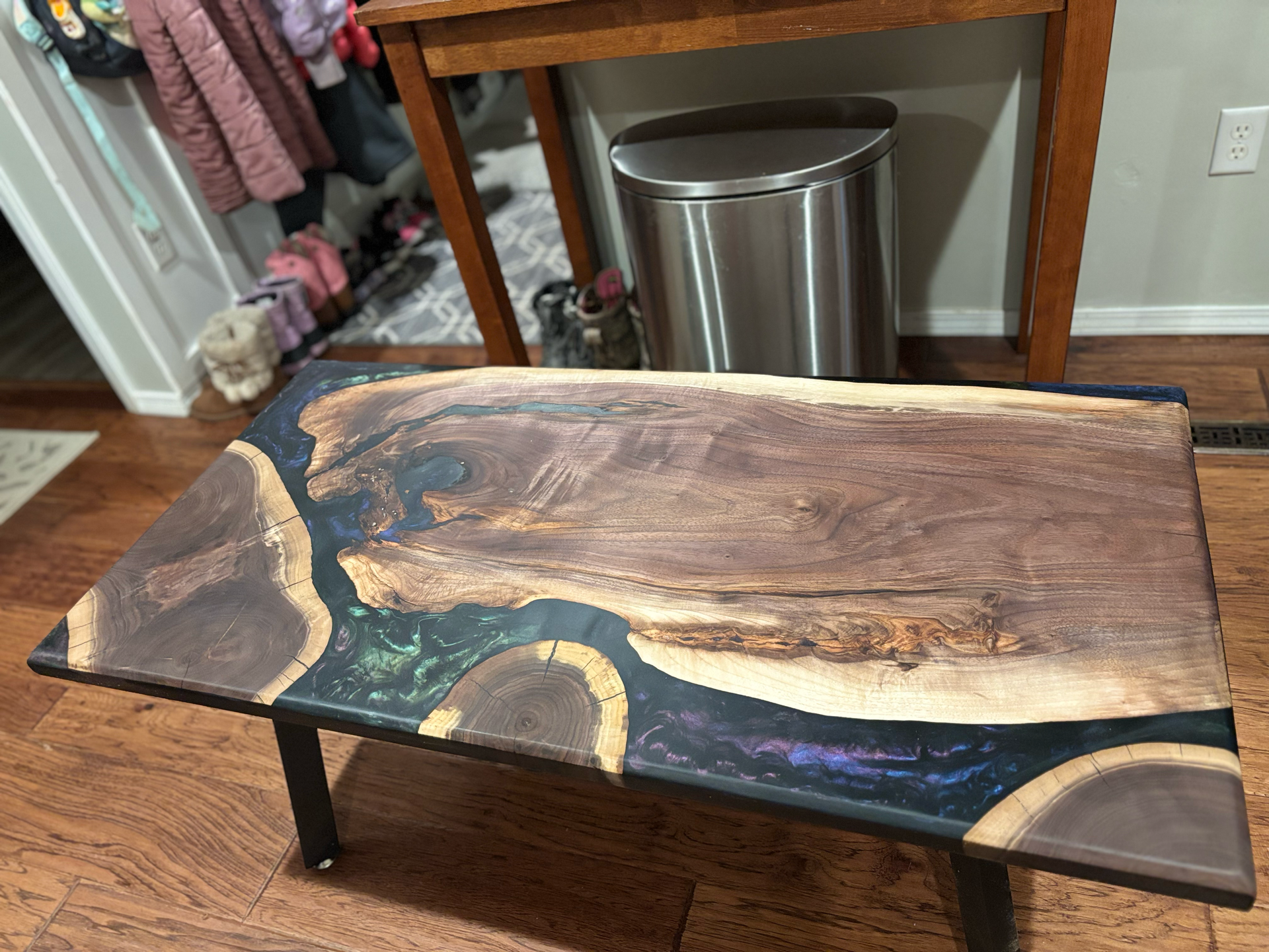 A coffee table made of wood and resin in a living room.