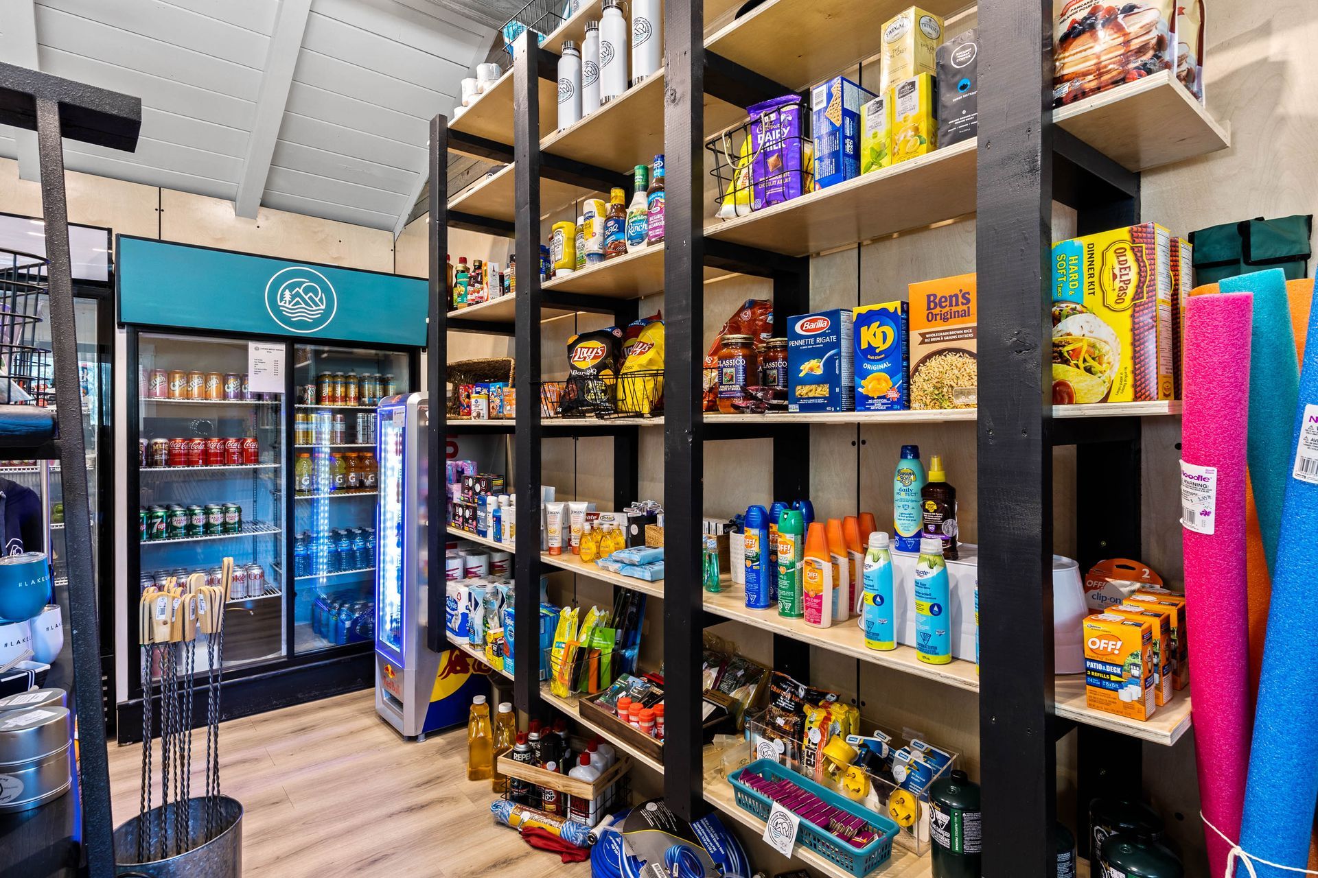 A store filled with lots of shelves and a refrigerator.