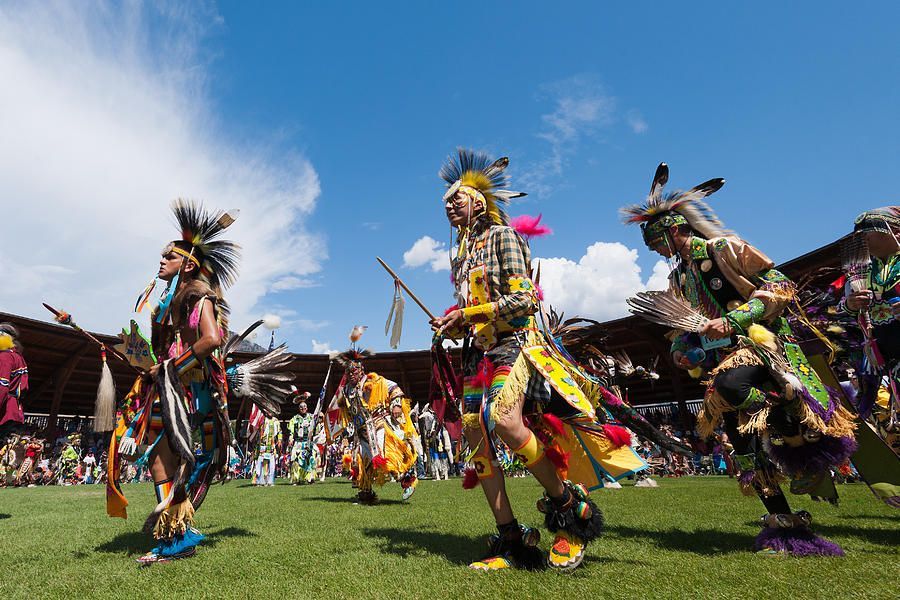 A group of people are dancing in a field.